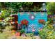 Inviting backyard scene featuring a quaint bench, lush greenery, and decorative elements creating a serene retreat at 1158 Shoreside Way, Mount Pleasant, SC 29464