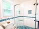 Beautiful bathroom with a glass enclosed shower with blue mosaic tile and a window at 1158 Shoreside Way, Mount Pleasant, SC 29464