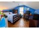 Bright and cozy bedroom with blue walls, a wooden bed, and a study area at 1158 Shoreside Way, Mount Pleasant, SC 29464