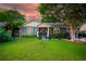 Beautiful home with a well-manicured lawn and classic brick facade at dusk at 1158 Shoreside Way, Mount Pleasant, SC 29464