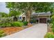 Well-maintained home with driveway, manicured lawn, and mature trees at 1158 Shoreside Way, Mount Pleasant, SC 29464