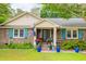 Charming brick home featuring teal shutters, a well manicured front yard and delightful curb appeal at 1158 Shoreside Way, Mount Pleasant, SC 29464
