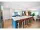 Bright kitchen boasts a large island, pendant lighting, stainless appliances and tiled backsplash at 1158 Shoreside Way, Mount Pleasant, SC 29464