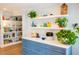 Beautiful kitchen with blue cabinets and white countertops featuring decorative shelving and natural light at 1158 Shoreside Way, Mount Pleasant, SC 29464