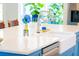 Bright kitchen island with white countertops, a stainless steel faucet, and blue cabinetry at 1158 Shoreside Way, Mount Pleasant, SC 29464