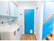 Functional laundry room with a blue door, cabinets and washer and dryer at 1158 Shoreside Way, Mount Pleasant, SC 29464