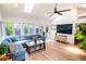 Relaxing sunroom features comfortable seating and a modern fan at 1158 Shoreside Way, Mount Pleasant, SC 29464