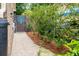 Landscaped side yard with gravel path and privacy fence with decorative art at 1158 Shoreside Way, Mount Pleasant, SC 29464