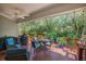 Inviting covered deck features comfortable seating, string lights, and a view of the green backyard and trees at 1250 Wide Water Ct, Charleston, SC 29412