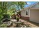 Backyard view showcases a stone table and bench set surrounded by trees, ideal for peaceful outdoor moments at 1250 Wide Water Ct, Charleston, SC 29412
