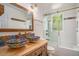 Bright bathroom with colorful vessel sinks and a glass door shower tub combination at 1250 Wide Water Ct, Charleston, SC 29412
