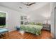 Bright bedroom featuring hardwood floors, a ceiling fan, and vibrant tropical-themed bedding at 1250 Wide Water Ct, Charleston, SC 29412