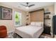 Stylish bedroom with a Murphy bed, shelves, and a view to the outside at 1250 Wide Water Ct, Charleston, SC 29412