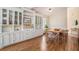 Bright dining area with built-in cabinets, a hardwood floor, and a modern table set at 1250 Wide Water Ct, Charleston, SC 29412