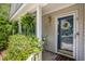 Inviting front entrance with a wreath, charming foliage, and a view of the neighborhood at 1250 Wide Water Ct, Charleston, SC 29412
