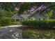 Charming single story home with beautiful landscaping and a lush tree shading the yard and long driveway at 1250 Wide Water Ct, Charleston, SC 29412