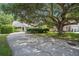 Charming single story home with beautiful landscaping and a lush tree shading the yard and long driveway at 1250 Wide Water Ct, Charleston, SC 29412