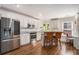 Bright, white kitchen featuring stainless steel appliances, granite countertops, and bar stool seating at 1250 Wide Water Ct, Charleston, SC 29412