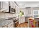 Well-lit kitchen features white cabinets, granite countertops, and stainless steel appliances at 1250 Wide Water Ct, Charleston, SC 29412