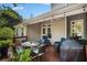 Covered back patio with dining set, lounge chairs, and grill at 1250 Wide Water Ct, Charleston, SC 29412