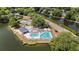Aerial view displays community pool and tennis courts bordered by waterway and manicured landscaping at 1250 Wide Water Ct, Charleston, SC 29412