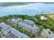 Scenic aerial view of waterfront apartment complex, bridge, and harbor with sailboats at 130 River Landing Dr # 3202, Charleston, SC 29492