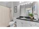 Well-lit bathroom featuring granite countertop vanity, white cabinets, and neutral shower curtain at 130 River Landing Dr # 3202, Charleston, SC 29492
