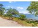 Breathtaking water view with a distant bridge and a bench on the sandy shore at 130 River Landing Dr # 3202, Charleston, SC 29492