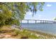 Scenic water view featuring a bridge, boats, and lush green trees along the shoreline at 130 River Landing Dr # 3202, Charleston, SC 29492