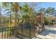 Outdoor grilling area with a stainless steel grill built into a brick structure near a pool and fence at 130 River Landing Dr # 7106, Charleston, SC 29492