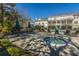 Community hot tub near chairs and tables is surrounded by trees, plants and apartment buildings at 130 River Landing Dr # 7106, Charleston, SC 29492