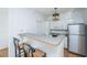 Charming kitchen with breakfast bar, white cabinets, updated appliances and modern light fixture at 130 River Landing Dr # 7106, Charleston, SC 29492