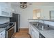 Galley kitchen featuring stainless steel appliances, granite countertops, and white cabinets at 130 River Landing Dr # 7106, Charleston, SC 29492