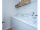 Laundry room with a white washer and dryer, plus a wire rack shelf for storage at 130 River Landing Dr # 7106, Charleston, SC 29492