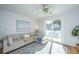 Comfortable living room boasts bright natural light, a large sofa, and easy access to outdoor balcony at 130 River Landing Dr # 7106, Charleston, SC 29492