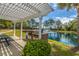 Brick outdoor grilling area with a stainless steel grill near pond at 130 River Landing Dr # 7106, Charleston, SC 29492