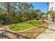 A small putting green surrounded by trees and landscaping near apartments at 130 River Landing Dr # 7106, Charleston, SC 29492