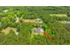 Aerial view of a charming home surrounded by verdant trees, with a view of neighboring houses in a serene, leafy neighborhood at 1375 Tannanger Trl, Awendaw, SC 29429
