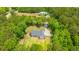 Aerial view of a residence with a pristine lawn and backyard, encircled by mature trees and a charming wooden fence at 1375 Tannanger Trl, Awendaw, SC 29429