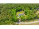 High aerial perspective of house showcasing fenced in backyard in a heavily wooded area at 1375 Tannanger Trl, Awendaw, SC 29429