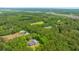 Panoramic aerial view showcasing a house enveloped by lush greenery and a neighboring wetland environment at 1375 Tannanger Trl, Awendaw, SC 29429
