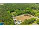 An aerial view of a home with a pool and an expansive yard in a private wooded setting at 1375 Tannanger Trl, Awendaw, SC 29429