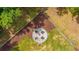 Aerial view of fire pit area with Adirondack chairs and curated landscape design at 1375 Tannanger Trl, Awendaw, SC 29429