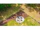 Aerial view showcasing a fire pit area surrounded by manicured landscaping and a fenced yard at 1375 Tannanger Trl, Awendaw, SC 29429