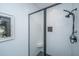 Modern bathroom shower featuring white subway tile, a black-trimmed glass door, and stylish fixtures at 1375 Tannanger Trl, Awendaw, SC 29429