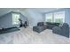 Large bonus room with sectional couch and a workout area with stationary bike and weights at 1375 Tannanger Trl, Awendaw, SC 29429