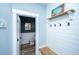 Cozy entryway featuring a bench, shelf with hooks, and a charming decor, leading to a powder room at 1375 Tannanger Trl, Awendaw, SC 29429