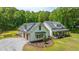 Charming home exterior featuring an attached garage, flag-draped porch, and landscaped front yard at 1375 Tannanger Trl, Awendaw, SC 29429