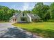 White two-story home with a two-car garage and large, landscaped front yard at 1375 Tannanger Trl, Awendaw, SC 29429