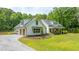 Home exterior showing driveway and well-manicured lawn that enhances curb appeal at 1375 Tannanger Trl, Awendaw, SC 29429